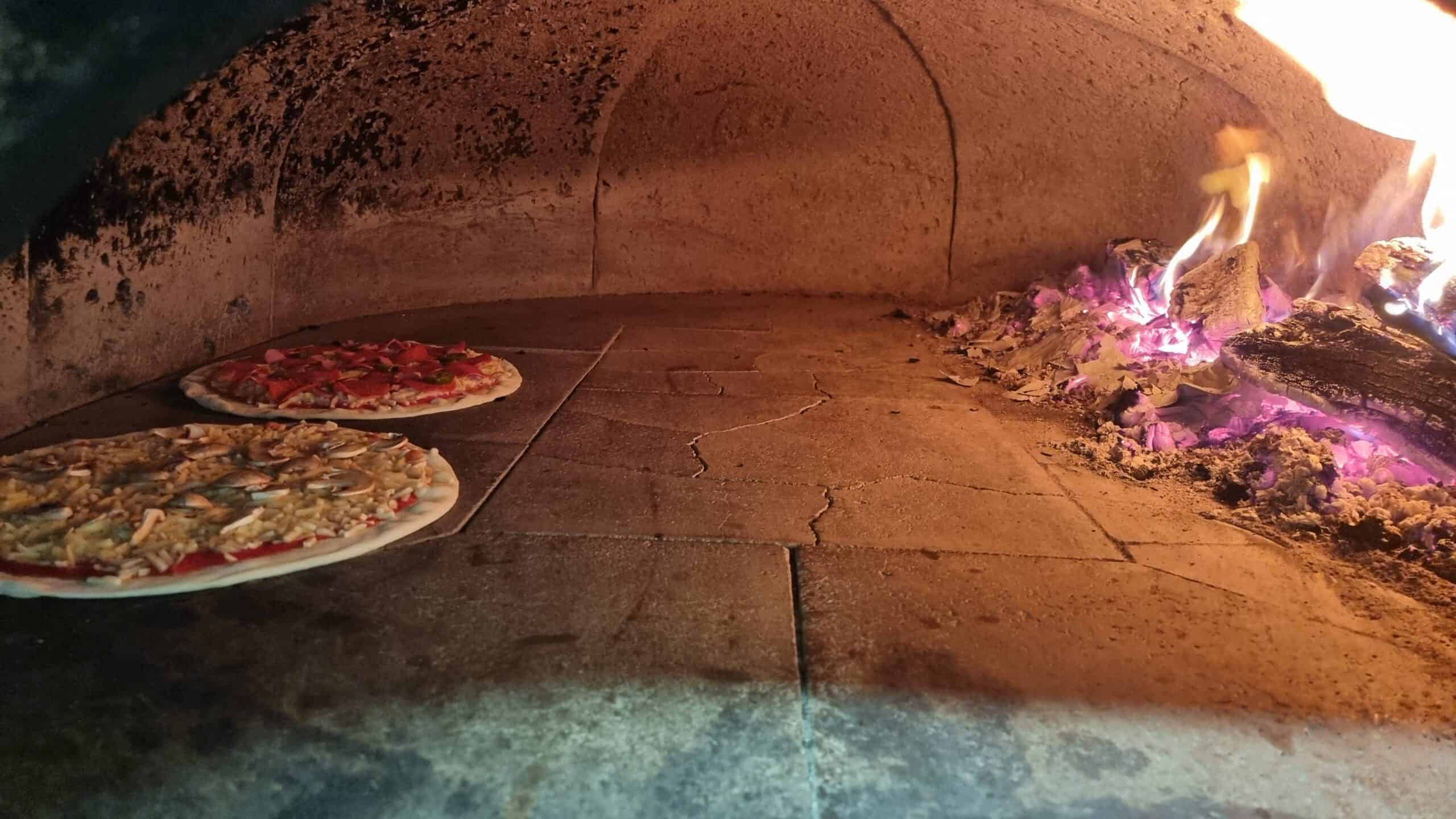 Wood-fired pizza oven with pizzas - Nosta restaurant Cork